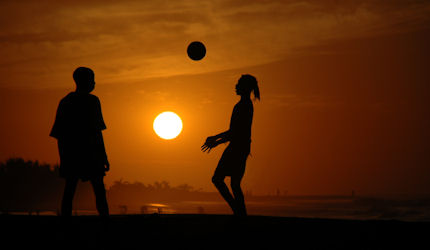 Soccer at sundown on a Gambian beach